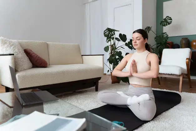 The woman is doing yoga at home