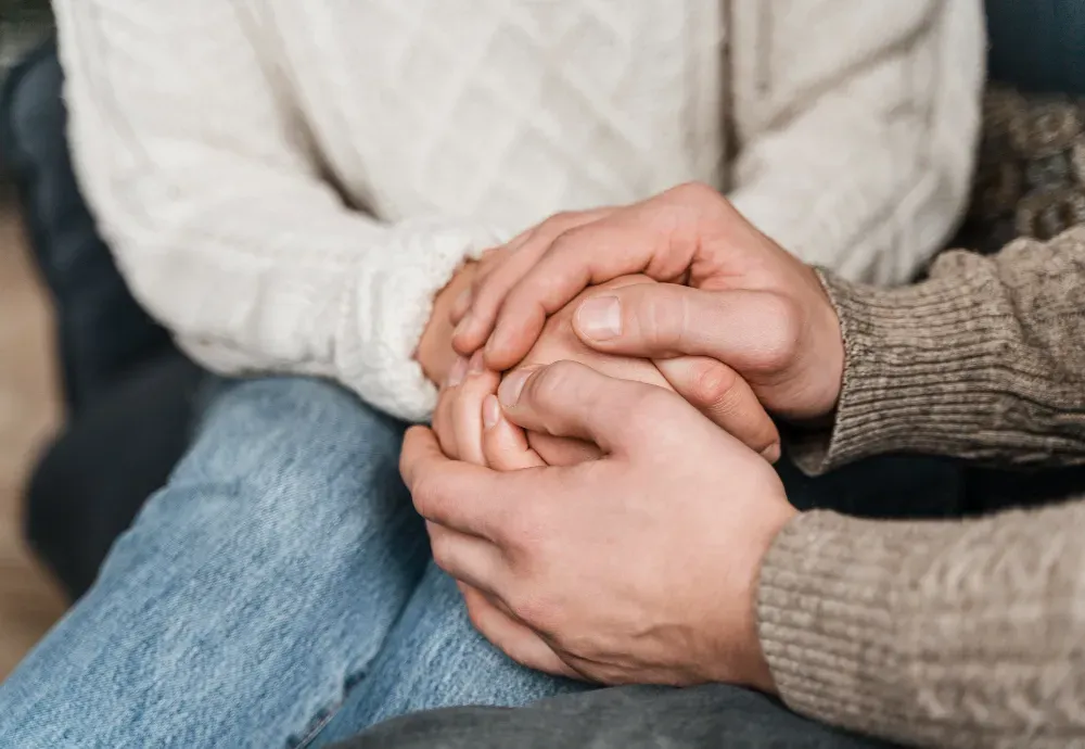 Man holdning woman hands to rebuild trust