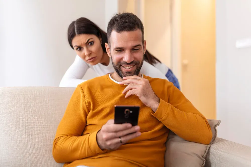 Woman checking on boyfriend when using his phone