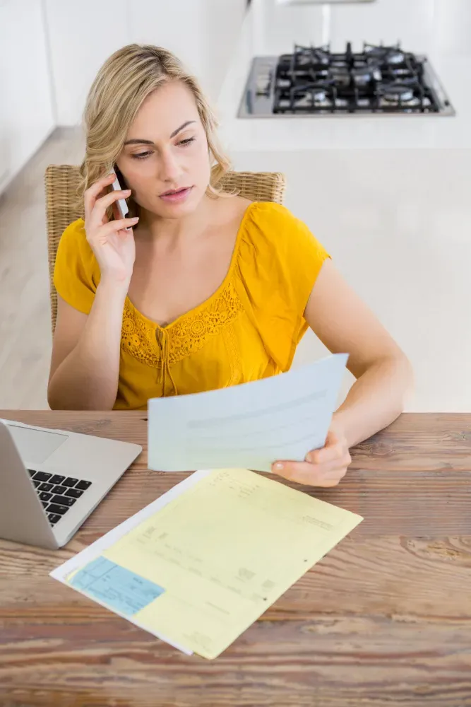 Woman speaking to her phone holding carrier text records