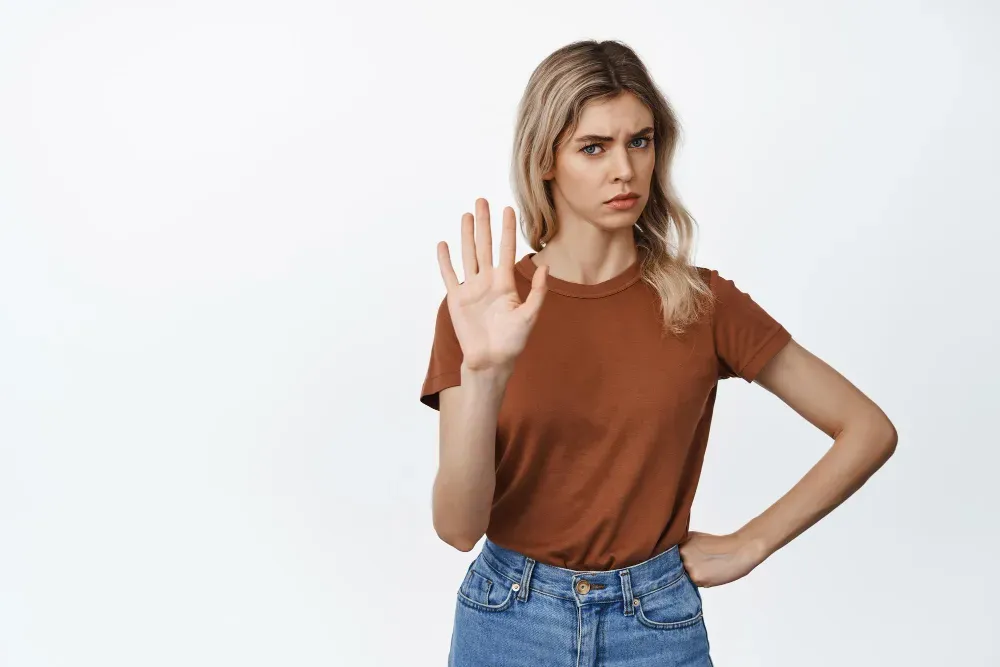 Woman setting a boundary with her hand